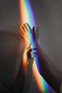Persons-hands-with-rainbow-colors-3693901