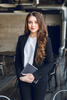 Brunette-business-woman-with-wavy-long-hair-blue-eyes-stands-holding-notebook-hands_197531-343_(1)